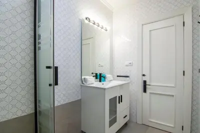 a white bathroom with a sink and a mirror at GuestReady - Tranquil Haven in Canyamelar in Valencia