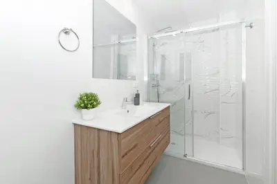 a bathroom with a shower with a sink and a shower at GuestReady - Piso moderno con vistas a la Marina in Valencia