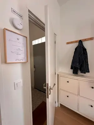 a room with a door leading to a bedroom with a dresser at Apartaestudio muy próximo Valencia in Burjasot