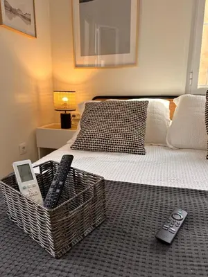a bedroom with a bed with remote controls on it at Apartaestudio muy próximo Valencia in Burjasot