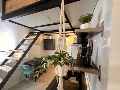 a loft apartment with a hammock hanging from the ceiling at Apartaestudio muy próximo Valencia in Burjasot