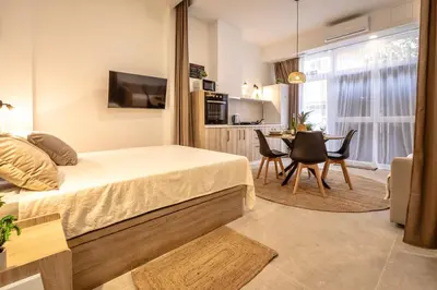 a bedroom with a bed and a table with chairs at Чудовий новий Лофт поруч з містом наук in Valencia