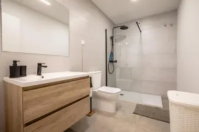 a bathroom with a sink and a toilet and a shower at Чудовий новий Лофт поруч з містом наук in Valencia