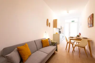 a living room with a couch and a table at FLORIT FLATS - The Maritim Metro Station Suites in Valencia