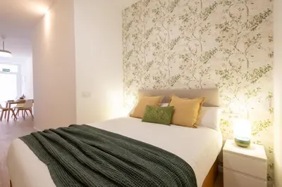 a bedroom with a large bed with a wall mural at FLORIT FLATS - The Maritim Metro Station Suites in Valencia