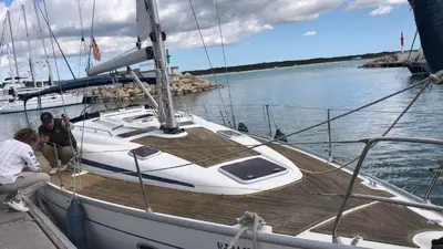 two people sitting on a boat in the water at Velero en puerto de valencia in Pinedo