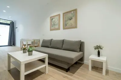 a living room with a couch and two tables at VLC HOST- Sant Jordi in Valencia
