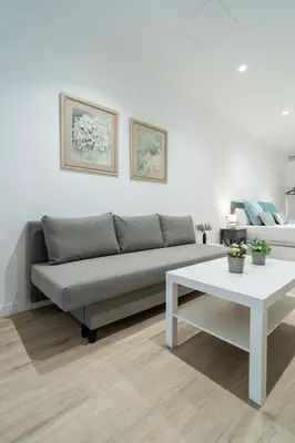 a living room with a couch and a table at VLC HOST- Sant Jordi in Valencia