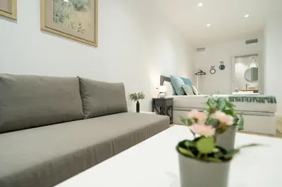 a living room with a couch and a bed at VLC HOST- Sant Jordi in Valencia