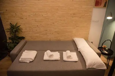 a bed with two towels on top of it at Lofts plaza JM Orense C in Valencia