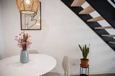 a white table with a vase of flowers on it at Lofts plaza JM Orense C in Valencia