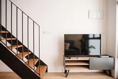 a staircase in a living room with a mirror at Lofts plaza JM Orense C in Valencia