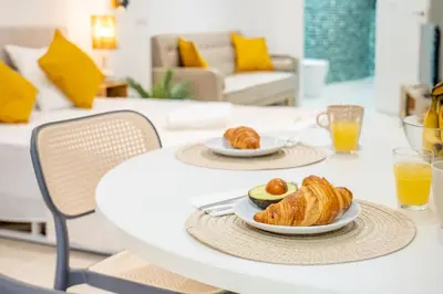 a table with two plates of croissants and orange juice at VLC HOST- Islas Canarias in Valencia