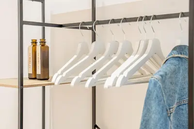 a closet with white hangers and bottles at VLC HOST- Islas Canarias in Valencia