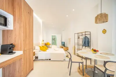a living room with a white couch and a table and chairs at VLC HOST- Islas Canarias in Valencia