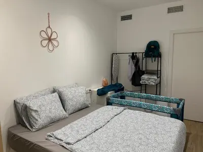 a bedroom with a couch and a bed in a room at Quiet room in a park close to the sea & beach & subway No-4 in Valencia