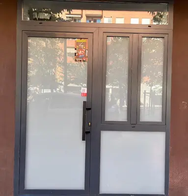 a door with two windows on a building at Quiet room in a park close to the sea & beach & subway No-4 in Valencia