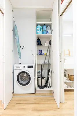 a laundry room with a washing machine in a closet at Main Lofts Valencia in Valencia