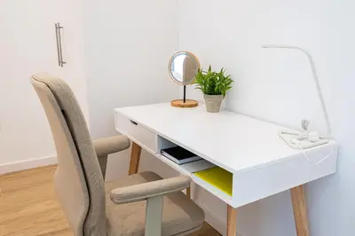 a white desk with a mirror and a chair at Main Lofts Valencia in Valencia