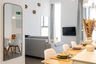 a living room with a couch and a table with chairs at Main Lofts Valencia in Valencia