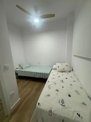 a bedroom with a bed and a ceiling fan at Gran apartamento a pie de calle in Valencia