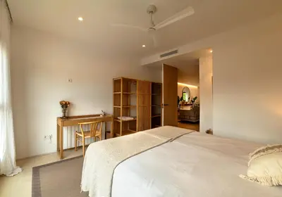 a bedroom with a white bed and a desk at Design Apartment with swimming pool Ciudad de Ciencias in Valencia