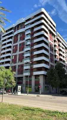 a large apartment building with red and white at Design Apartment with swimming pool Ciudad de Ciencias in Valencia
