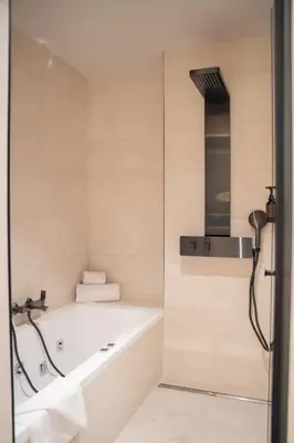 a bathroom with a bath tub and a shower at Calderona Wellness in Bétera