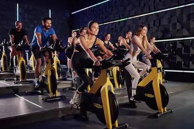 a group of people on exercise bikes in a gym at Calderona Wellness in Bétera