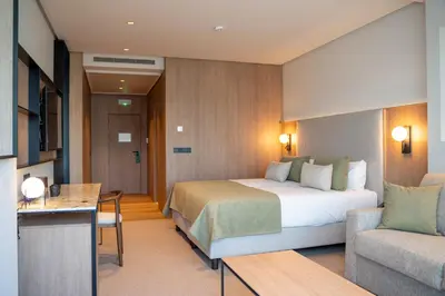 a hotel room with a bed and a couch at Calderona Wellness in Bétera
