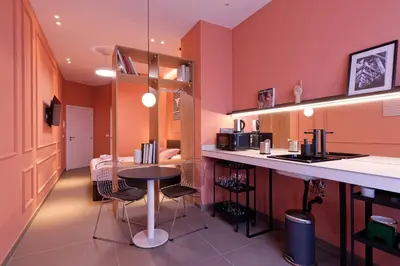 a kitchen with a table and chairs in a room at Osito Hub - Llorens in Valencia