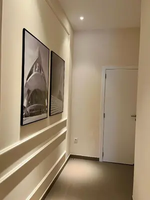 a hallway with two framed photographs on the wall at Osito Hub - Llorens in Valencia