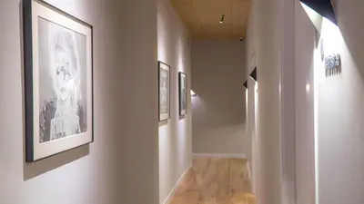 a hallway with pictures on the walls of a museum at Hotel Sleep Turia music & art in Lliria