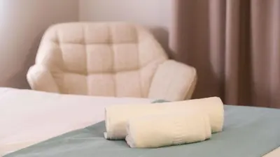 a bedroom with a chair and a bed and a pillow at Hotel Sleep Turia music & art in Lliria