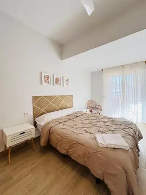 a bedroom with a large bed and a window at Sun & Sea Cullera in Cullera