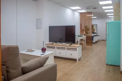 a living room with a couch and a large screen tv at Acogedor estudio en el Centro de Valencia in Valencia