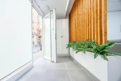 an empty hallway with plants in a building at Acogedor estudio en el Centro de Valencia in Valencia
