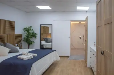 a bedroom with a bed with towels on it at Acogedor estudio en el Centro de Valencia in Valencia