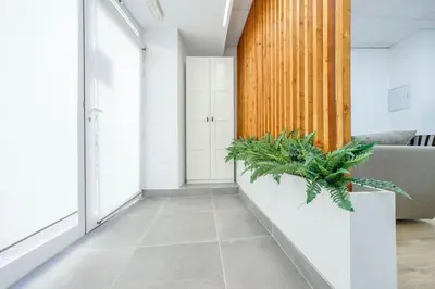 a hallway with a couch and plants in it at Acogedor estudio en el Centro de Valencia in Valencia