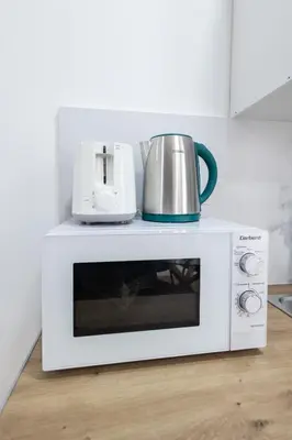a white microwave with a pot on top of it at Imprenta Sorolla by Concept in Valencia