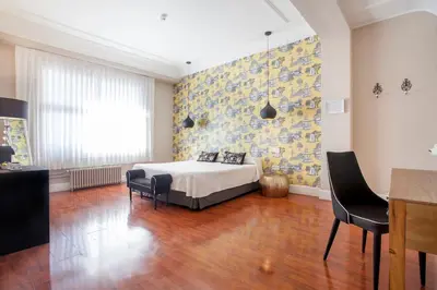 a bedroom with a bed and a table and chairs at Hi Valencia Boutique in Valencia