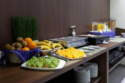 a buffet with fruits and vegetables on a table at Hotel Olympia Universidades in Valencia