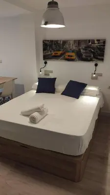a large bed in a bedroom with a large white bedspread at B2, Estudio independiente junto Aeropuerto Valencia in Manises