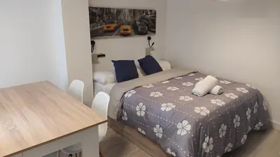 a small bedroom with a bed and a table at B2, Estudio independiente junto Aeropuerto Valencia in Manises