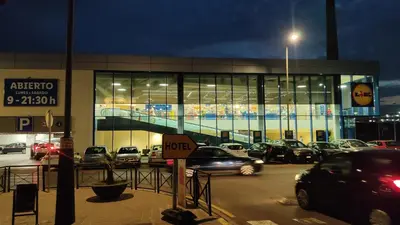 a parking lot with cars parked in front of a building at B2, Estudio independiente junto Aeropuerto Valencia in Manises