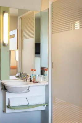 a bathroom with a sink and a mirror at Ibis Budget Valencia Alcasser in Silla