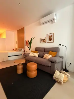 a living room with a couch and a bed at Loft Taronja Ruzafa-Parque central in Valencia
