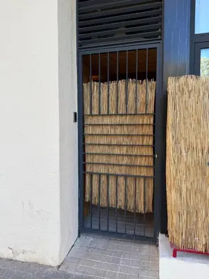 a black door with a metal gate in front of a building at Loft Taronja Ruzafa-Parque central in Valencia