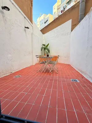 a patio with a table and a potted plant at Loft Taronja Ruzafa-Parque central in Valencia