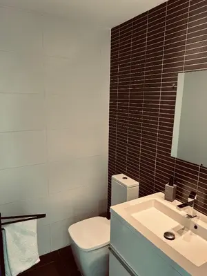 a bathroom with a white toilet and a sink at Mi Huésped Valencia, Aeropuerto Manises in Manises